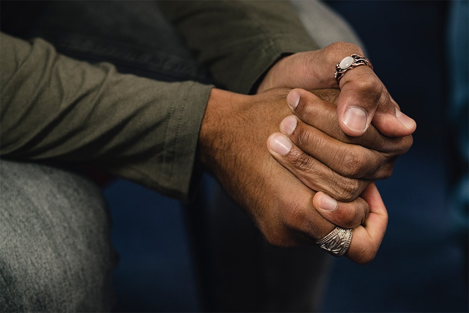 Man clutching his hands symbolising trauma for rewind technique