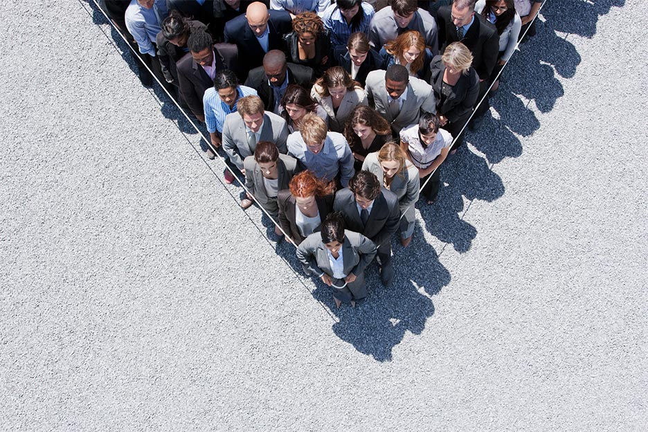 Business men and women trapped behind a rope, symbolising workplace stress