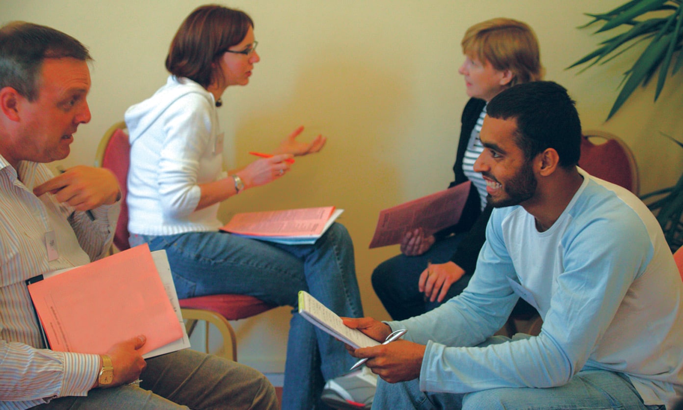 Group of adults learning and talking to each other