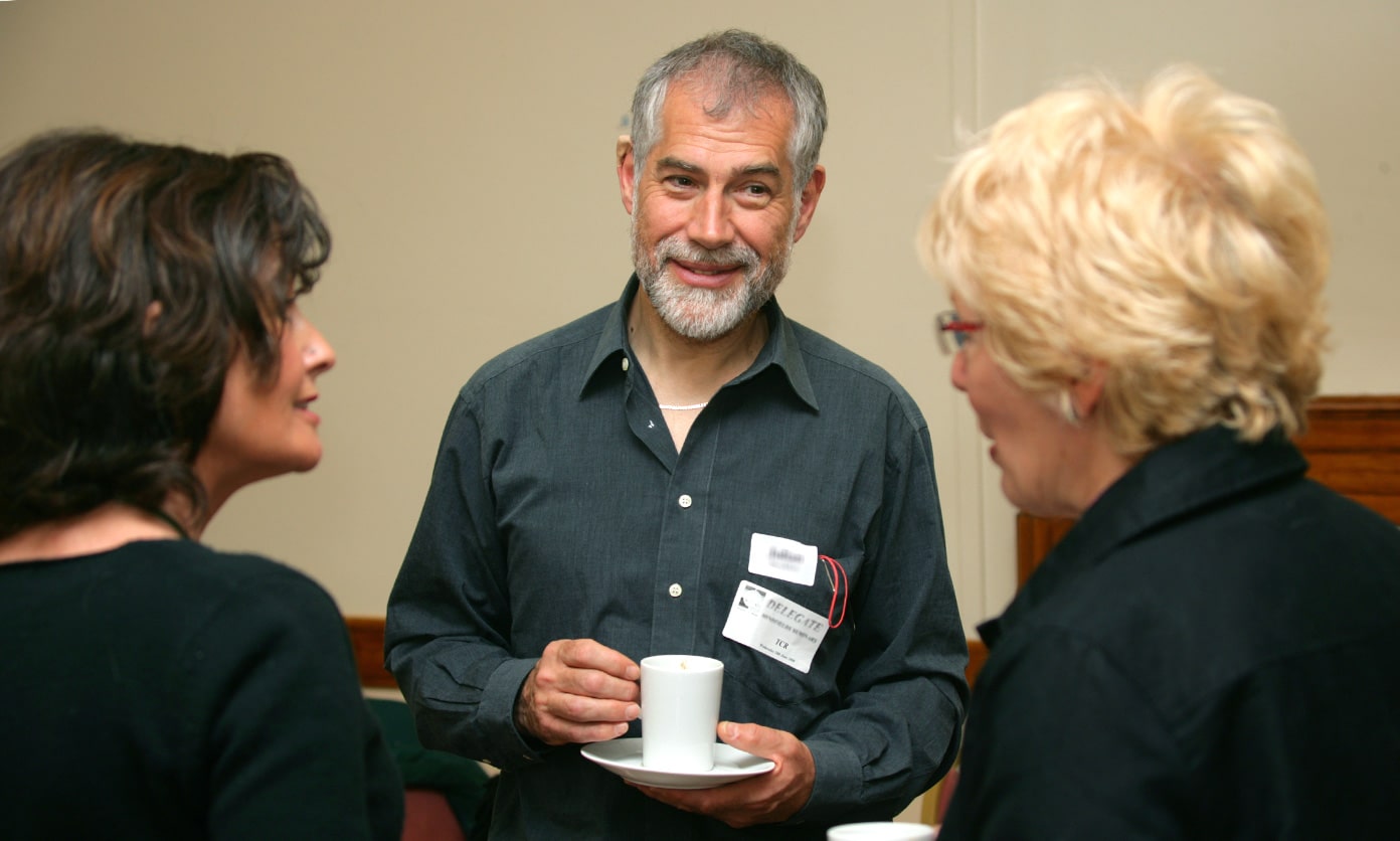 A men and two females talking during a tea break - human givens diploma