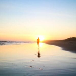 Photo of person running during sunset