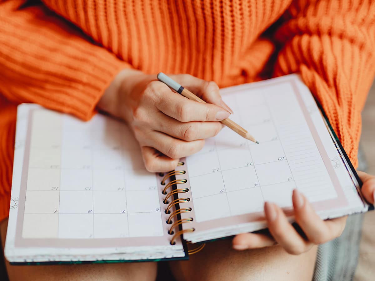 Photo of woman holding a diary