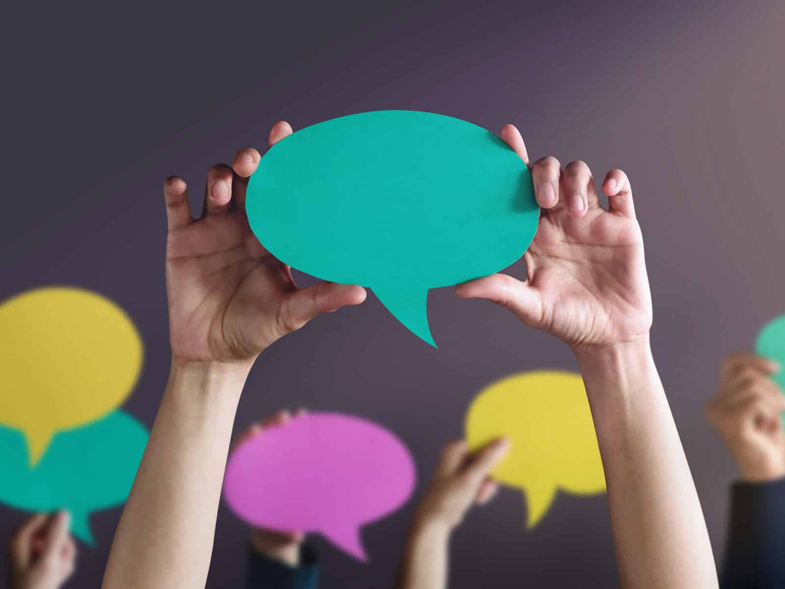 people holding speech bubbles