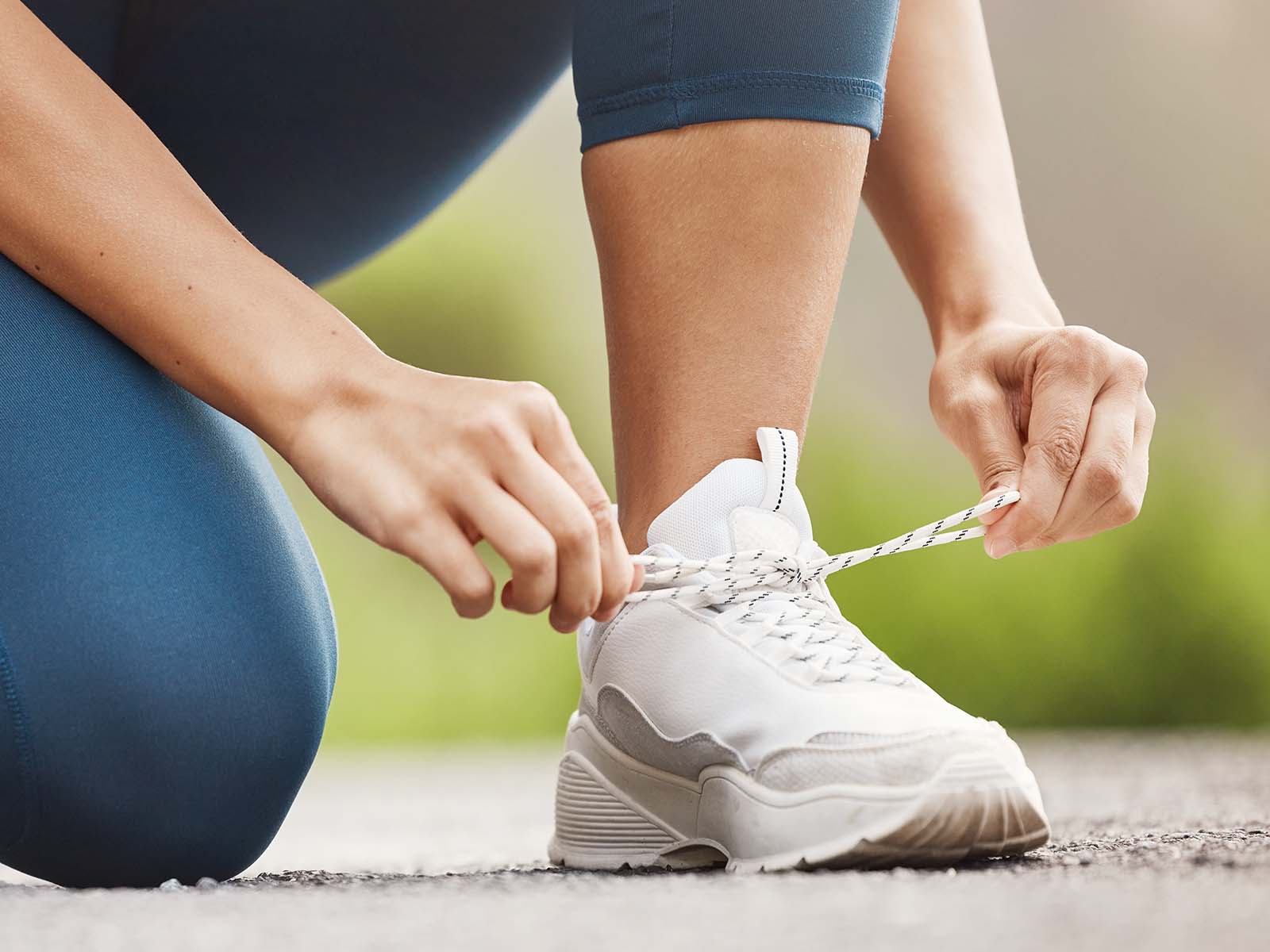 Woman runner tying her laces