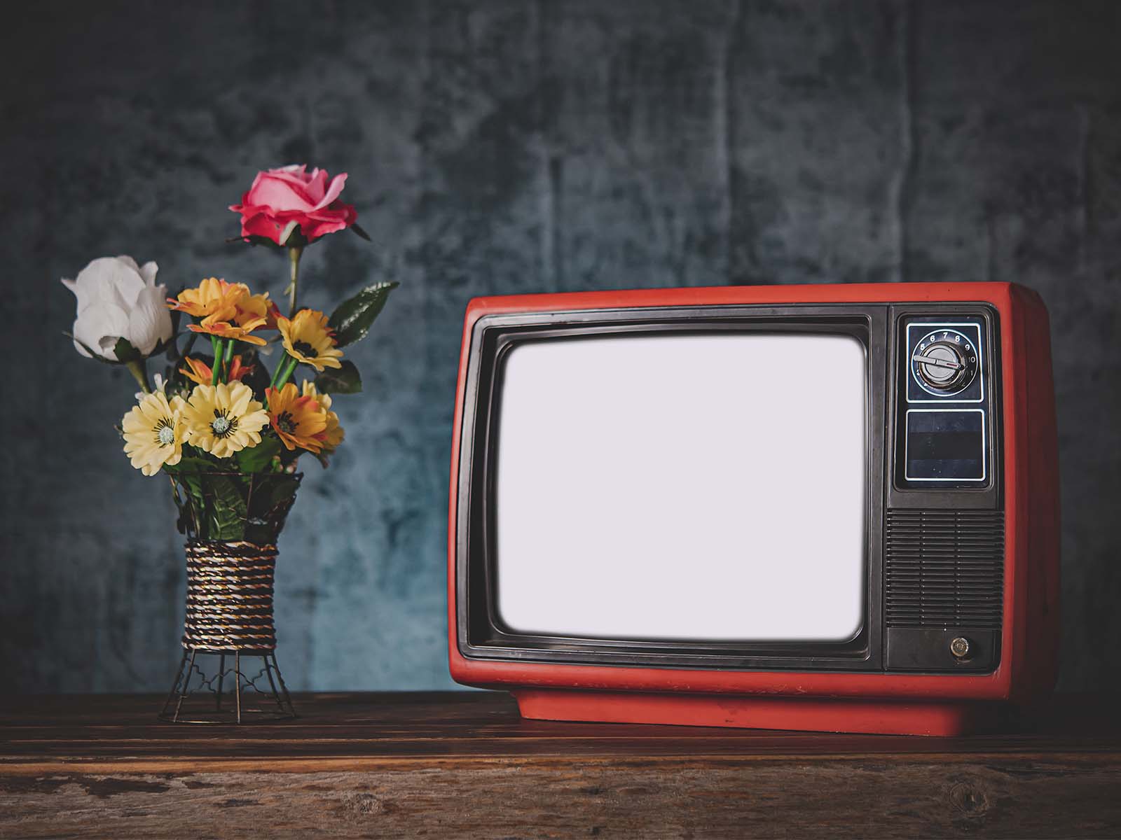 Still life image of TV and a vase of flowers